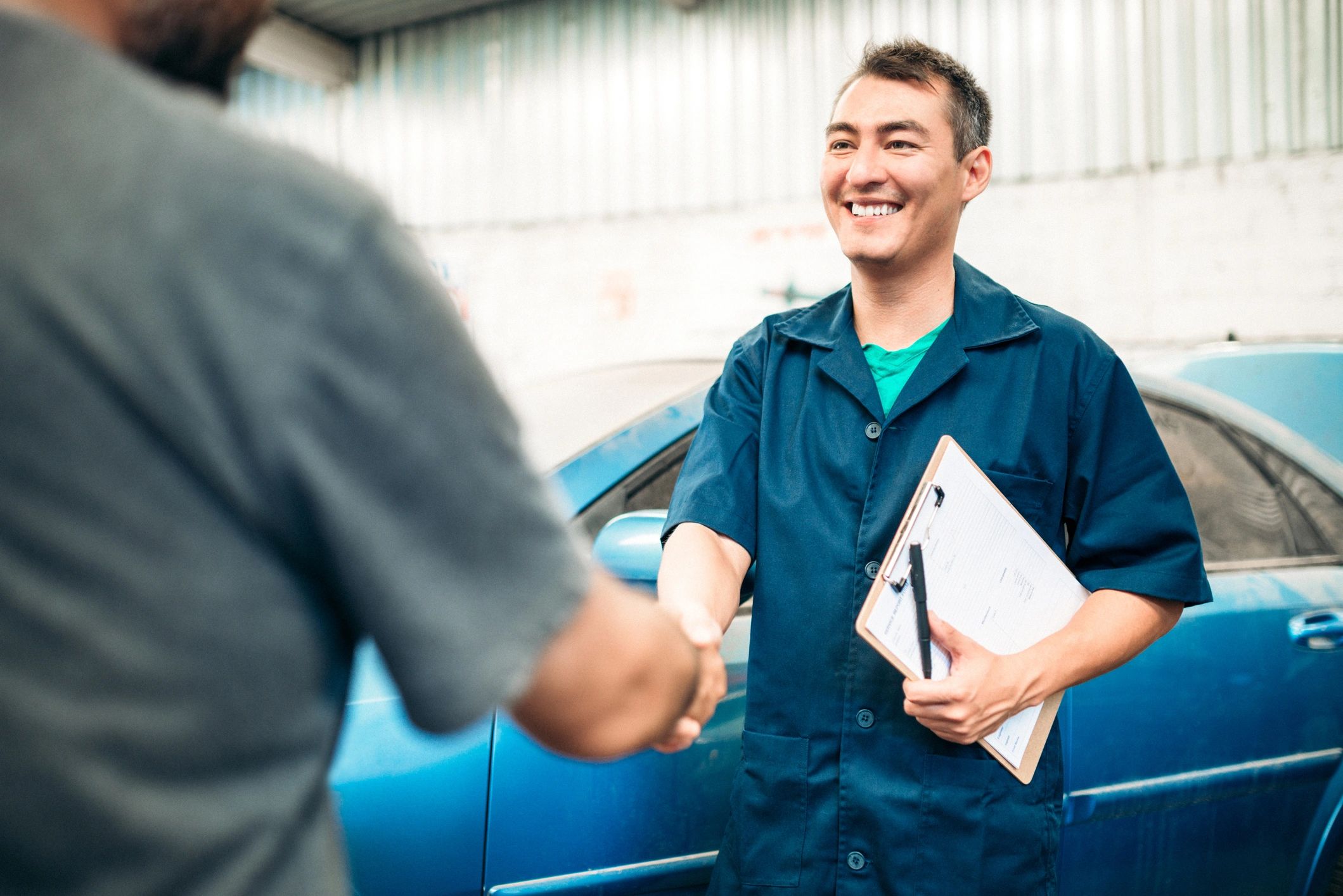 Customer shaking hands with an automotive service professional